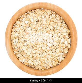 Rolled oats in wooden bowl isolated on white background. Stock Photo