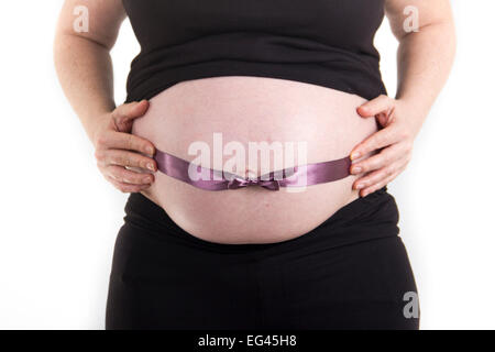 pregnant belly with purple ribbon Stock Photo