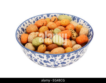 Seaweed peanuts in a blue and white porcelain bowl with a floral design, isolated on a white background Stock Photo