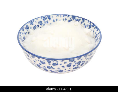 White caster sugar in a blue and white porcelain bowl with a floral design, isolated on a white background Stock Photo