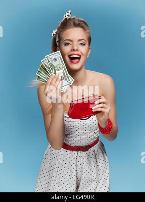 Excited young woman with dollars in her hands. Shopping concept Stock Photo