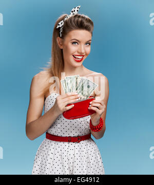 Cheerful attractive young lady holding cash and happy smiling. Shopping concept Stock Photo