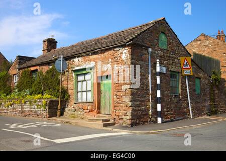 Old sandstone building in need of renovation. Kirkoswald, Eden Valley, Cumbria, England, UK Stock Photo