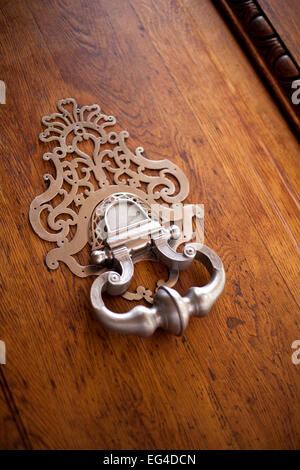 Stylish knocker on a wooden door of a French mansion Stock Photo