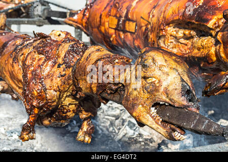 Whole roasted lamb on a steel spit. Selective focus with shallow depth of field. Stock Photo