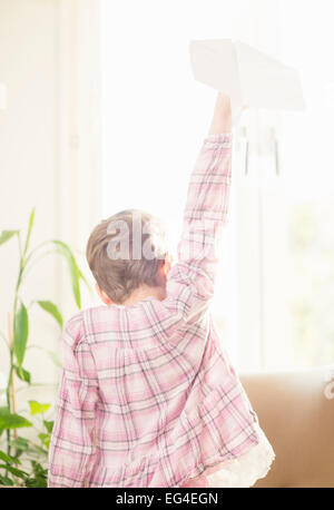 Little girl playing with paper airplane Stock Photo