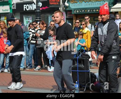 Cillian Murphy, wife Yvonne and their sons Malachy and Aran watch break-dance buskers Dublin City BBoys on Grafton Street  Featuring: Cillian Murphy,Yvonne McGuinness,Malachy Murphy,Aran Murphy Where: Dublin, Ireland When: 14 Aug 2014 Stock Photo