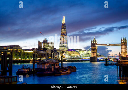 Tower Bridge and The Shard viewed from the north bank of the Thames at night. London, UK Stock Photo