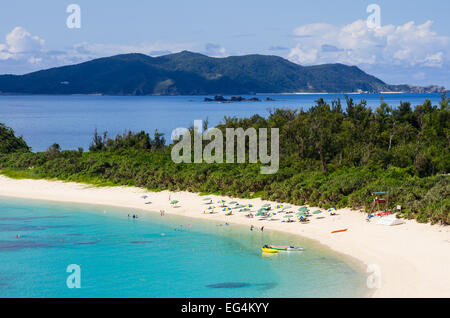 Beautiful Aharen Beach with tourists enjoying the sun and water on Tokashiki Island with Zamami Island behind, Okinawa, Japan Stock Photo