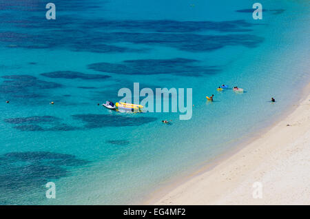 The famous 'Kerama Blue' of Aharen Beach with people snorkeling among the corals on Tokashiki Island, Okinawa, Japan Stock Photo