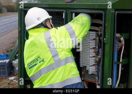 BT Openreach engineer working on a broadband internet fibre cabinet in the street Stock Photo