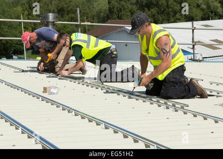 men working on a roof Stock Photo