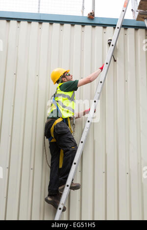 man climbing ladder Stock Photo