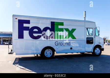 A FedEx delivery truck parked in a parking lot. Stock Photo