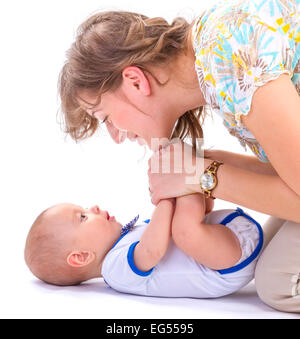 studio shot of baby boy lying on white floor Stock Photo