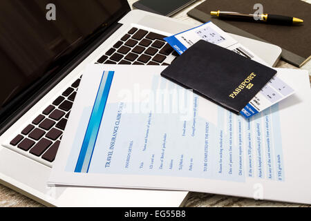 Travel insurance application form with a boarding pass and a passport Stock Photo