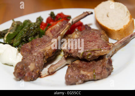 lamb racks with pimentos de padron and tomatos Stock Photo