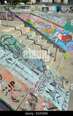 Skateboard park scene of graffiti and concrete steps at Golden Mille beachfront where skaters and trick bikes do stunts,Durban, KZN, South Africa Stock Photo