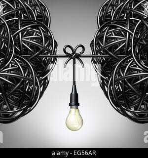 Team ideas and collaboration concept as two groups of tangled electric cord or wire with a light bulb connection tied together between the partners as a teamwork metaphor for success. Stock Photo