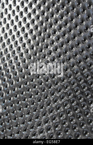 The metallic texture inside a washing machine drum. Stock Photo