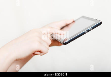 girl holding and clicking touchpad screen Stock Photo