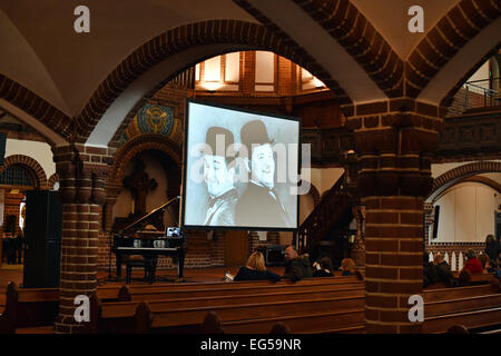 Berlin, Germany. 24th Jan, 2015. dpa-EXCLUSIVE - Silent film comedians Stan Laurel and Oliver Hardy are on display on a screen at the 'Passionskirche' church in Berlin, Germany, 24 January 2015. Pianist Carsten-Stephan Graf von Bothmer performs live music as part of a series of silent films. Photo: Jens Kalaene/dpa/Alamy Live News Stock Photo