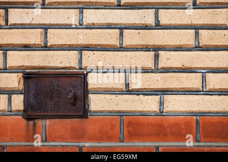 background from finishing bricks wall with ashpit door Stock Photo