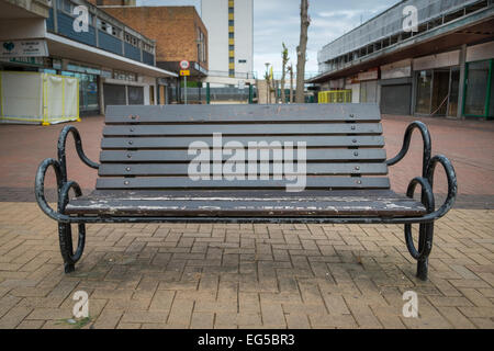 BRACKNELL, UK - AUGUST 11, 2013: A bench in an empty highstreet in the Berkshire town of Bracknell. Awaiting demolition to make Stock Photo