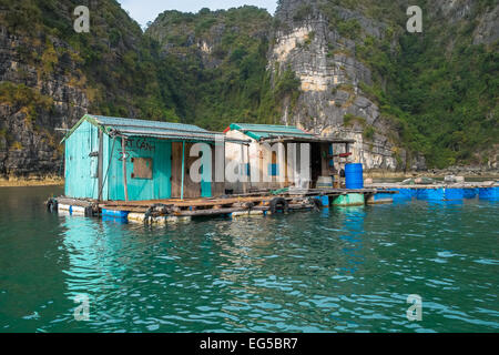 HALONG BAY, VIETNAM - JANUARY 28: Run down houses in a floating village on January 28, 2014 in Ha-long Bay, Vietnam. Stock Photo