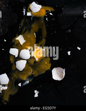 Broken egg on dark background, top view Stock Photo