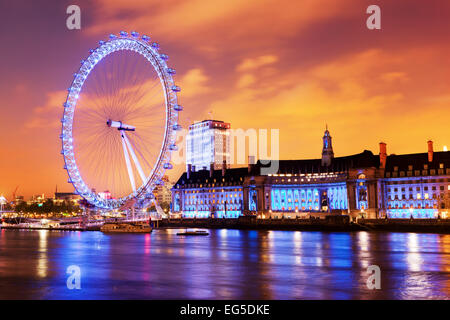 London, England the UK skyline in the evening. Ilumination of the London Eye and the buildings next to River Thames Stock Photo