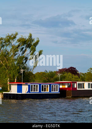 Wooden houseboats moored at Hickling Staithe in the Norfolk Broads an area of inland waterways in East Anglia Eastern England UK Stock Photo