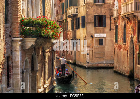 Venice, Italy. A romantic gondola floats on a narrow canal among old Venetian architecture Stock Photo