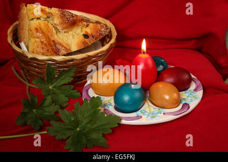 Easter eggs, cake and flowers - red background Stock Photo