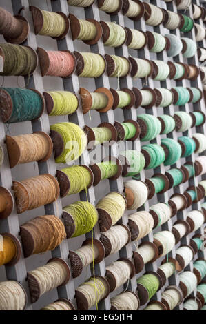 Spools of coloured threads on display in a Chinese carpet making factory Stock Photo