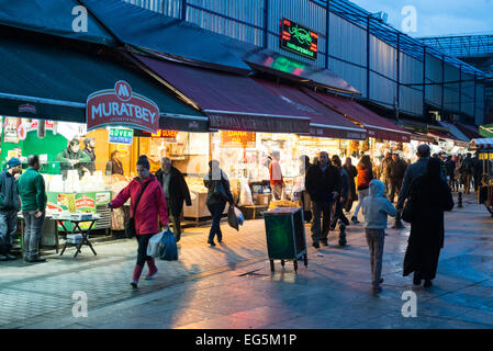 Spice Bazaar Shops Istanbul | ISTANBUL, Turkey — Shops line the Spice Bazaar (Mısır Çarşısı) in Istanbul's Eminönü quarter, near the Galata Bridge. Also known as the Egyptian Bazaar, it was built in the early 1660s as the commercial arasta of the New Mosque külliye, with the full complex inaugurated on 30 October 1665; its shop rents were legally dedicated to the perpetual upkeep of the adjacent mosque under the Ottoman vakıf system. One of the oldest covered markets in Istanbul — the third great covered bazaar of Ottoman Istanbul after the Grand Bazaar and the Tiryaki Çarşısı at the Süleymani Stock Photo