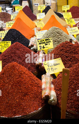 Spice Bazaar Spices And Herbs Istanbul Turkey | ISTANBUL — Mounds of dried mint, thyme and red pepper flakes crowd a vendor's stall at the Spice Bazaar, one of the market's roughly 88 historic vaulted shop units built along two perpendicular arms. Constructed in the 1660s as the third great covered bazaar of Ottoman Istanbul, after the Grand Bazaar and the Tiryaki Çarşısı, the market anchors the Eminönü quarter near the Golden Horn. Stock Photo