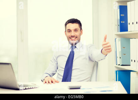 smiling businessman with laptop and documents Stock Photo