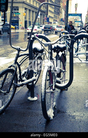 New York City - January 9, 2015:  View of bicycles locked along sidewalk in midtown Manhattan Stock Photo