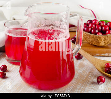 Cranberry drink with fresh berries on a wooden table. Selective focus Stock Photo