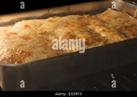 Lasagna in oven Stock Photo