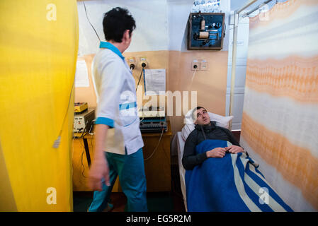 ATO soldier getting treatment in physiotherapy ward in Military Hospital, Ukraine. During Ukrainian-Russian conflict military hospitals overloaded for more than 30%. Most of clinics work with old soviet medical equipment, and lack of modern machines such as tomographs. 16 of February. Photo by Oleksandr Rupeta Stock Photo