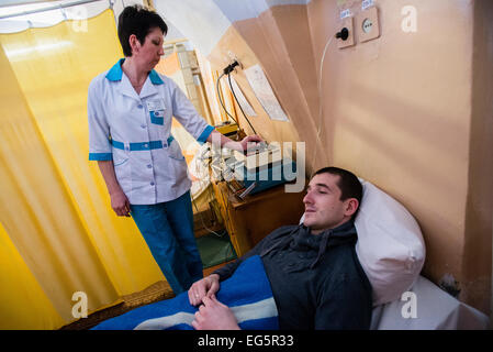 ATO soldier getting treatment in physiotherapy ward in Military Hospital, Ukraine. During Ukrainian-Russian conflict military hospitals overloaded for more than 30%. Most of clinics work with old soviet medical equipment, and lack of modern machines such as tomographs. 16 of February. Photo by Oleksandr Rupeta Stock Photo