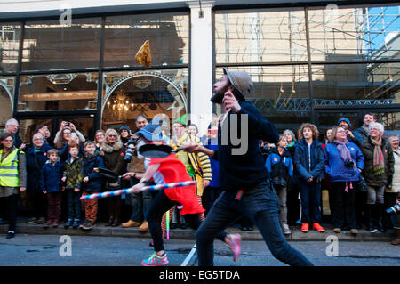 Shrove Tuesday pancake race,organised by Alternative Arts in aid of London Air Ambulance. Tossing the pancake at the finish line