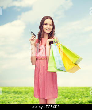 smiling woman in dress with many shopping bags Stock Photo