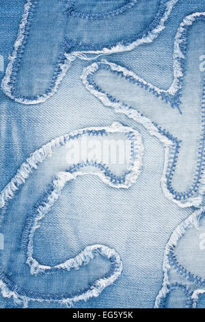 Letters stitched on denim, can be used as background Stock Photo