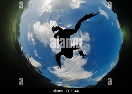 Common Toad (Bufo bufo) seen from below against a blue sky. Surrey, England, March. Did you know? It used to be believed that toads had a magical stone in their head;  however 'toadstones' which have been found were actually fossilised fish teeth. Stock Photo