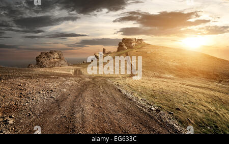 Evening over country road in high mountains Stock Photo
