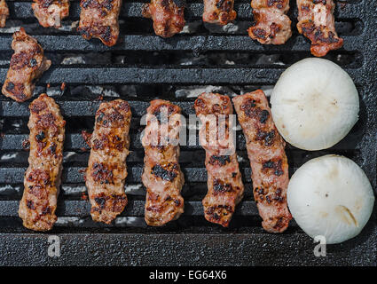 Cevapcici - Minced Meat Rolls and Champignons - White Mushrooms - on a grill Stock Photo