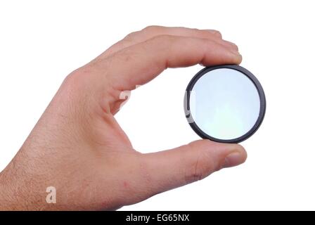 man hand holds a circular polarizer filter, isolated on white background Stock Photo